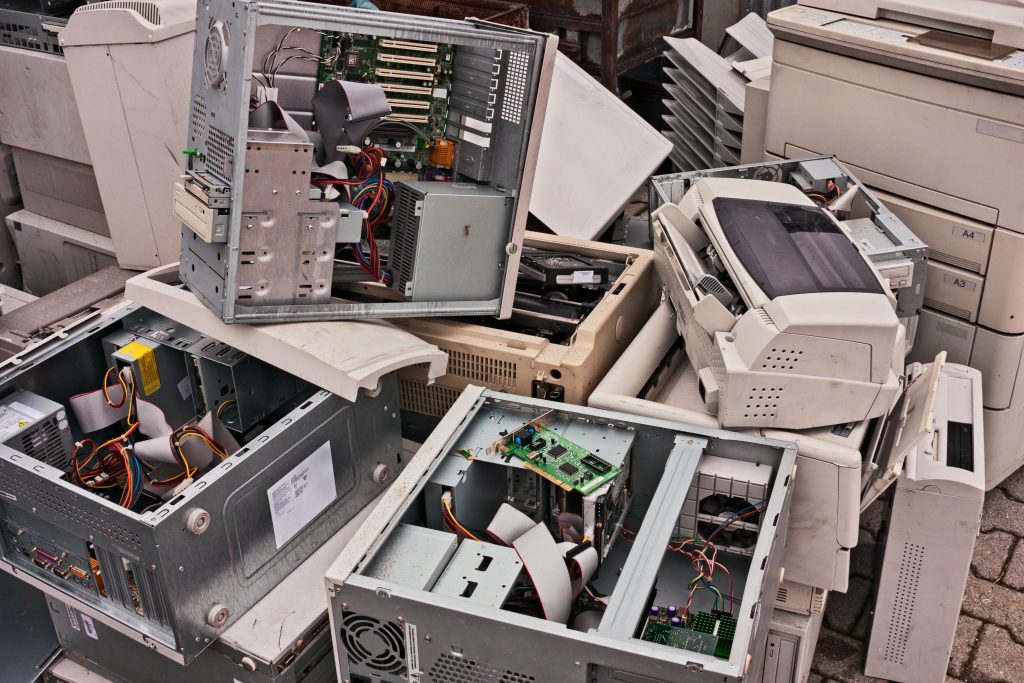 Computers and periherals such as printers piled up waiting to be securely desposed of and recycled.